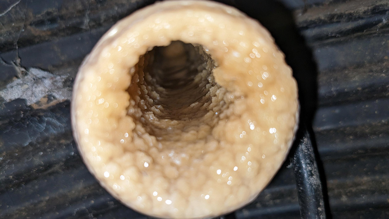 Calcium buildup on the inside of a blocked drain